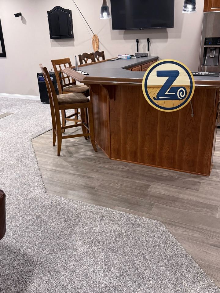 LVP and carpet across a finished Geist basement