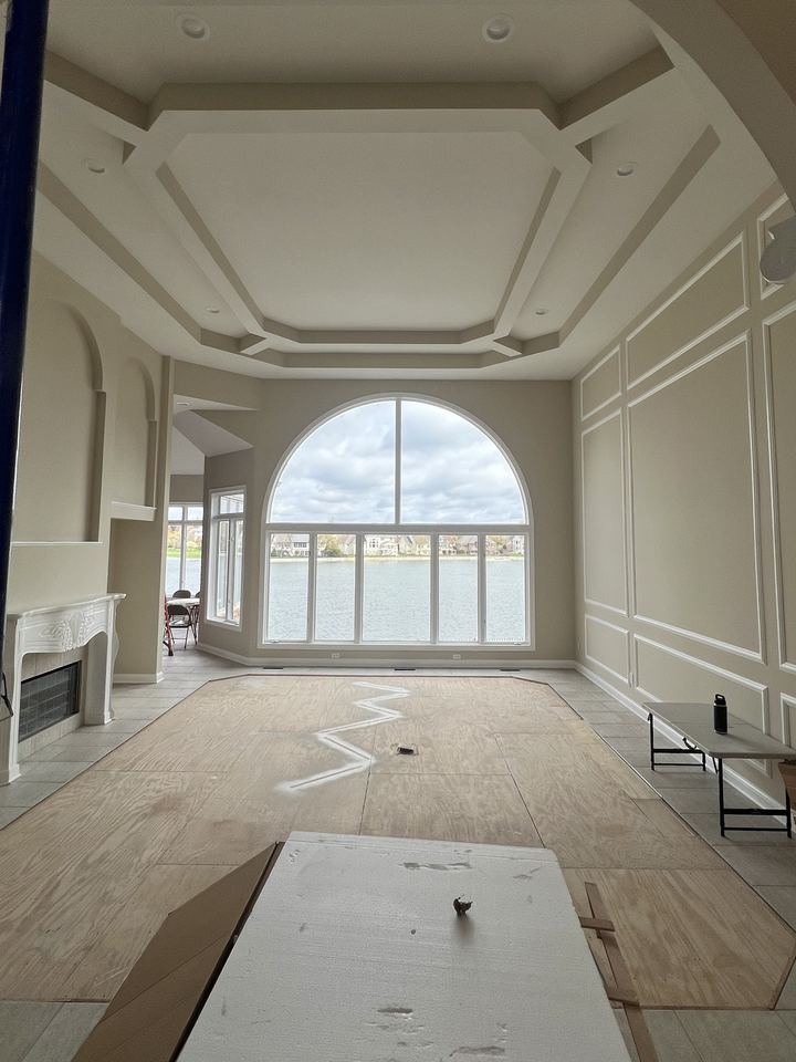 Before: Carmel lakefront great room with the carpet field cut out of the tile