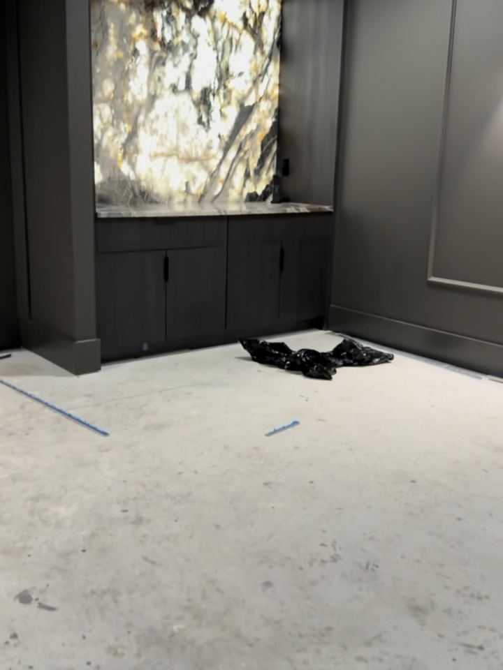 Before: the same theater slab facing the backlit onyx bar, Westfield