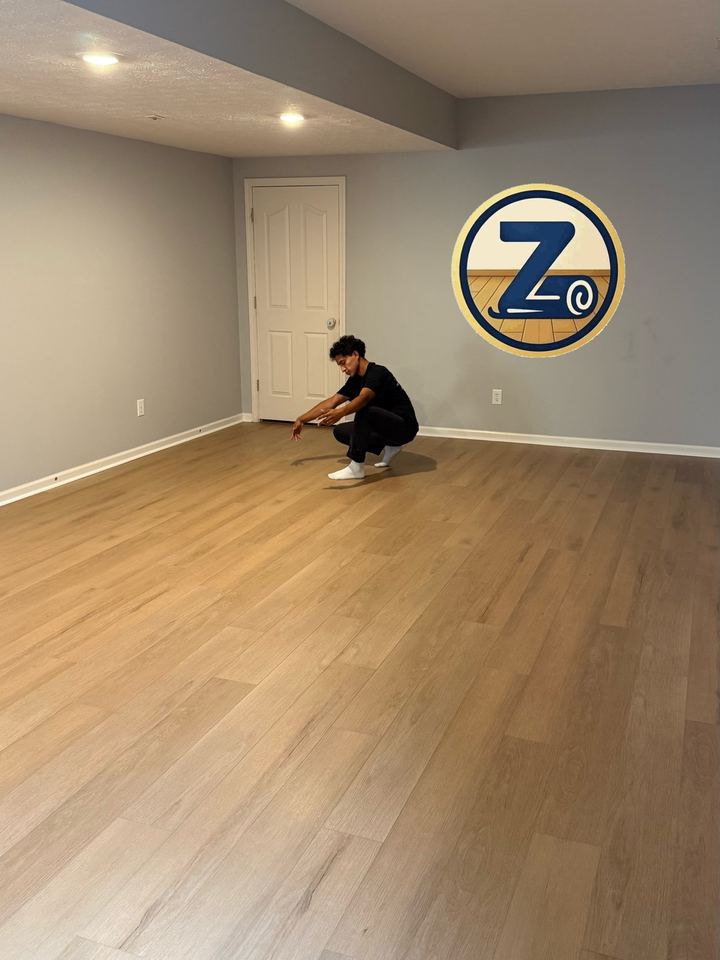 Irvin Diaz checking a plank seam on a finished LVP floor